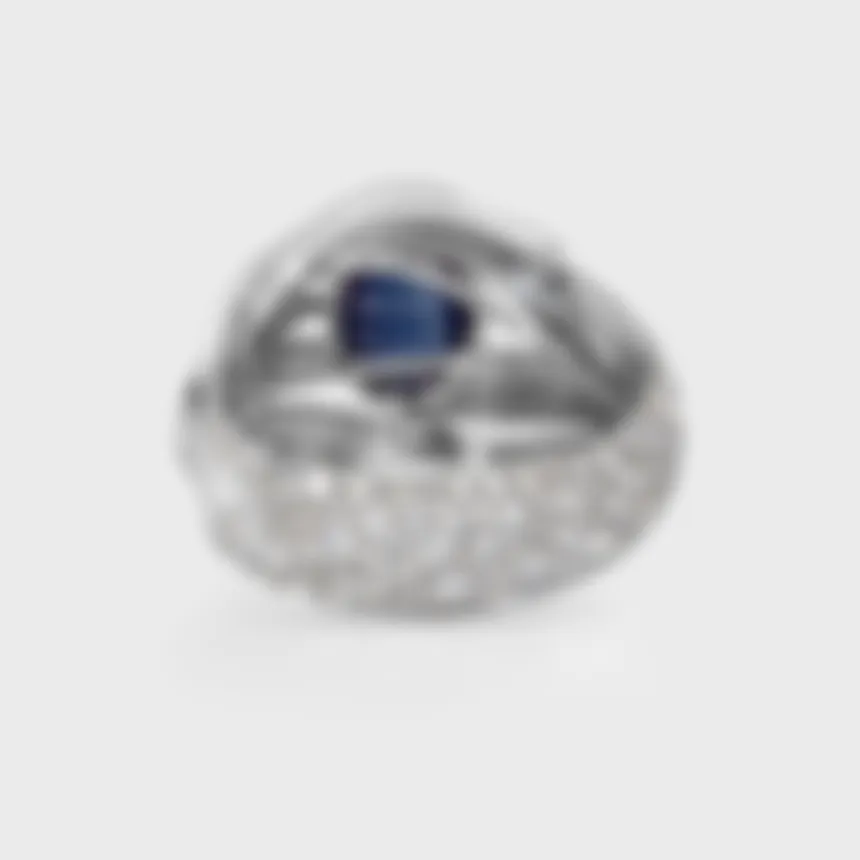 Astraea white gold ring by ValeOro with a blue sapphire in an openwork band paved with diamonds, back view