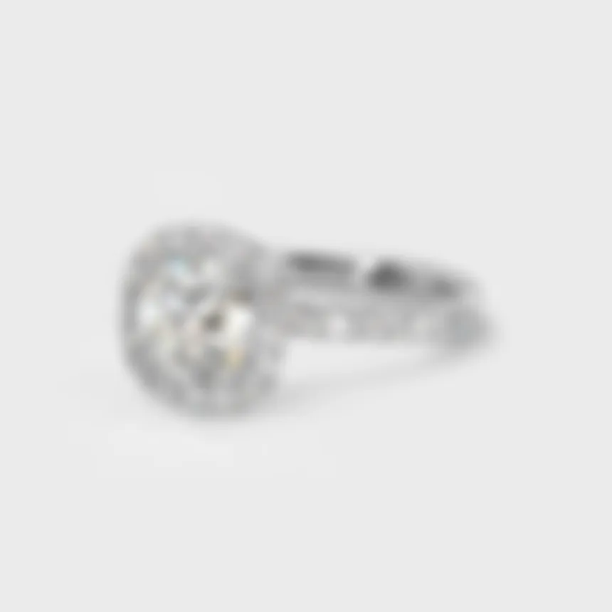 Radiance white gold ring by ValeOro with a round halo diamond and diamonds along the band, three-quarter view