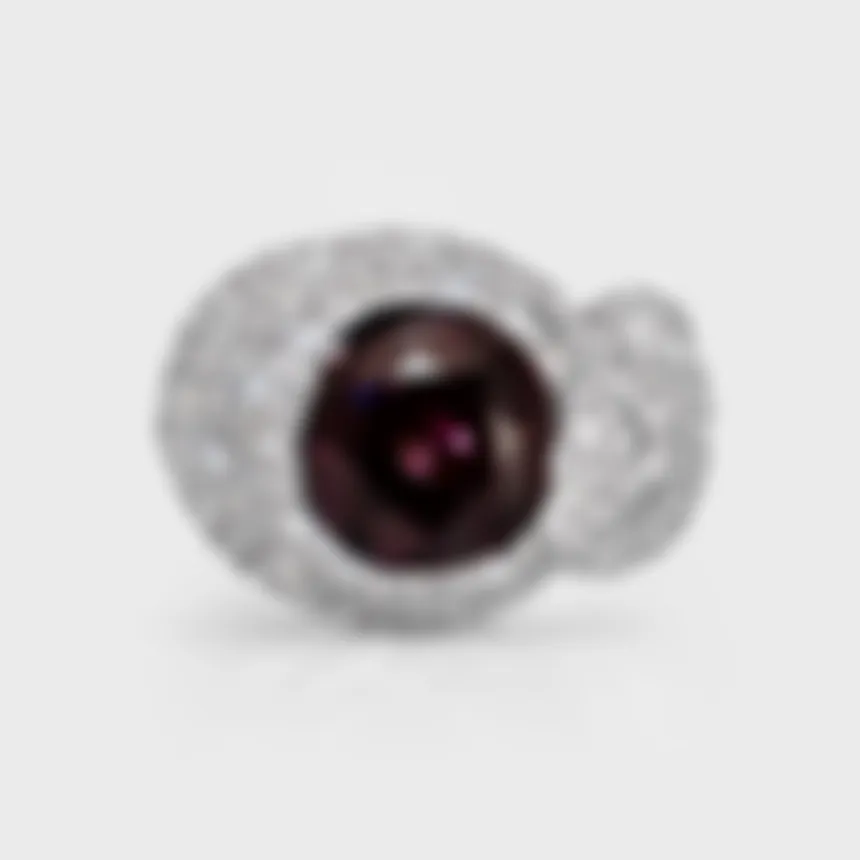 Liaison white gold ring by ValeOro with a round purple spinel set in a diamond bow, front view