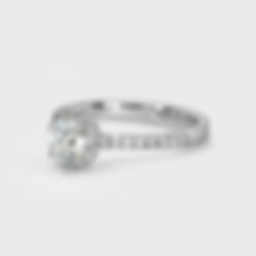 Aurora white gold ring by ValeOro with a round halo diamond and a pavé-set band, three-quarter view