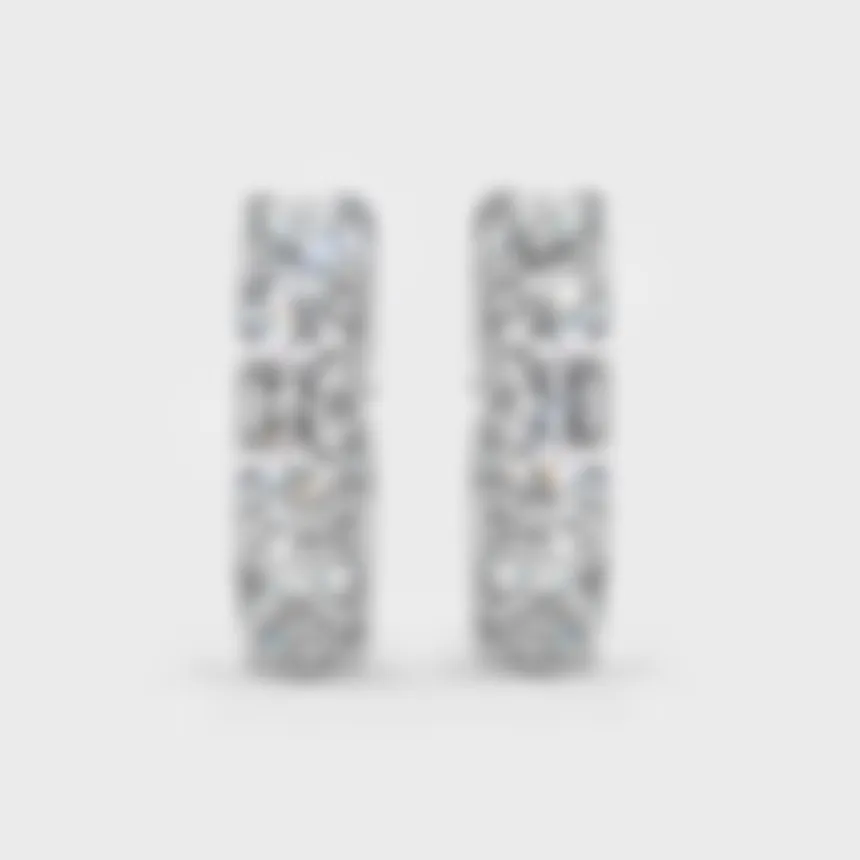 Gloss white gold hoop earrings by ValeOro with a line of large round diamonds, front view
