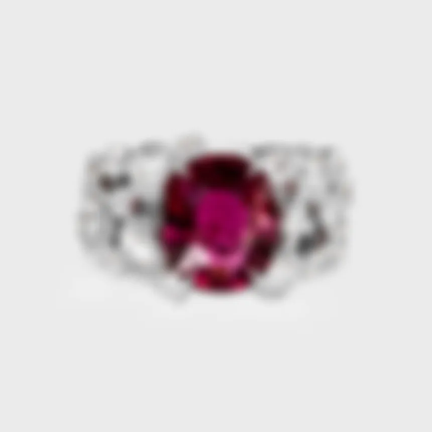 Ceres white gold ring by ValeOro with an oval red tourmaline flanked by diamonds in mirror bezel settings, front view