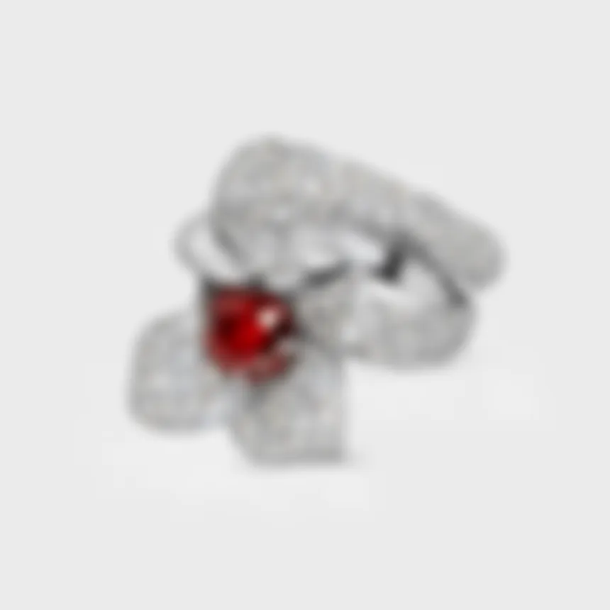 Lily white gold ring by ValeOro with a red sapphire in a diamond flower and pavé band, three-quarter view