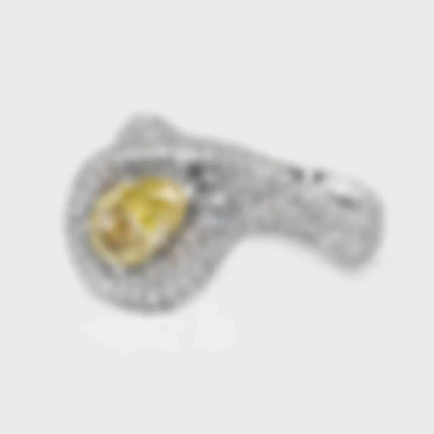 Yin-Yang white gold ring by ValeOro with a yellow pear diamond held between two waves of pavé, three-quarter view