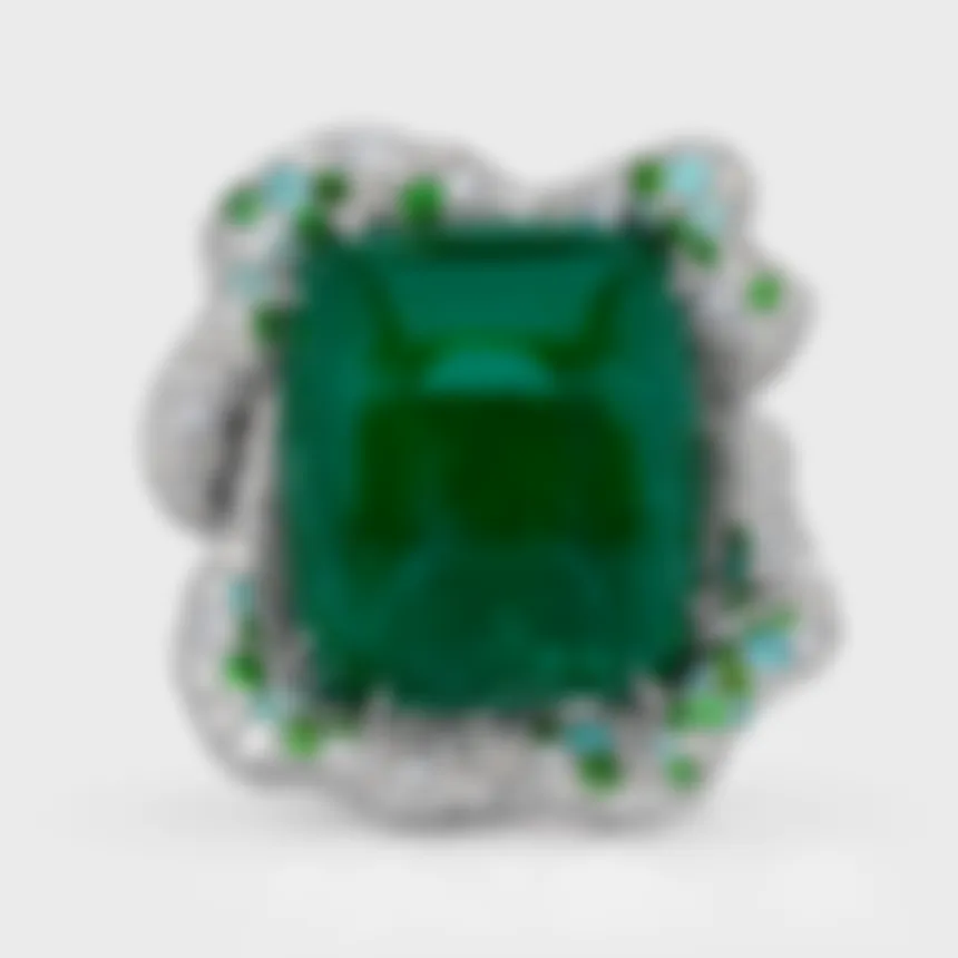 Crown of Ural white gold ring by ValeOro with a green cabochon emerald framed by diamonds and green accents, front view
