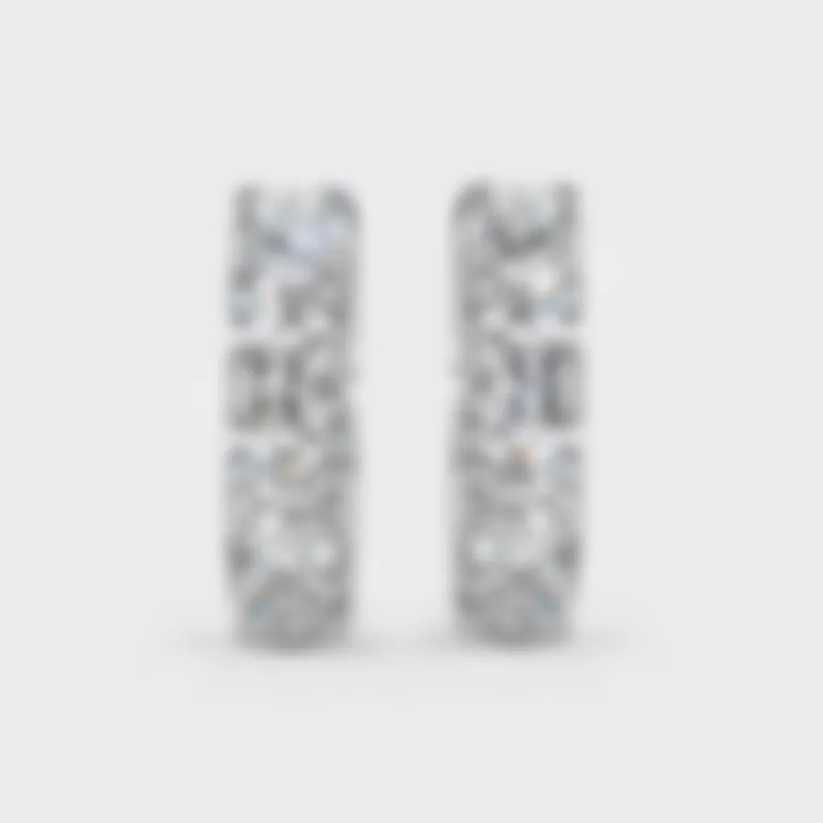 Gloss white gold hoop earrings by ValeOro with a line of large round diamonds, front view
