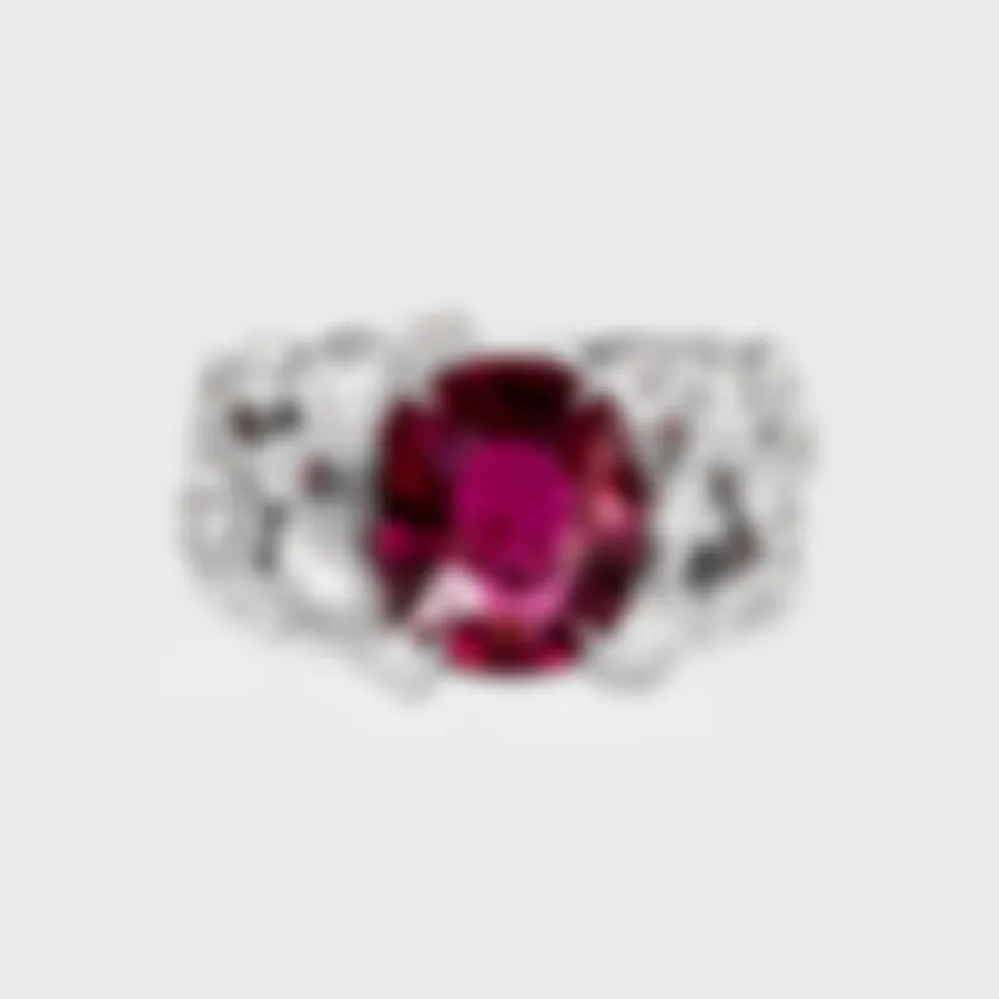 Ceres white gold ring by ValeOro with an oval red tourmaline flanked by diamonds in mirror bezel settings, front view