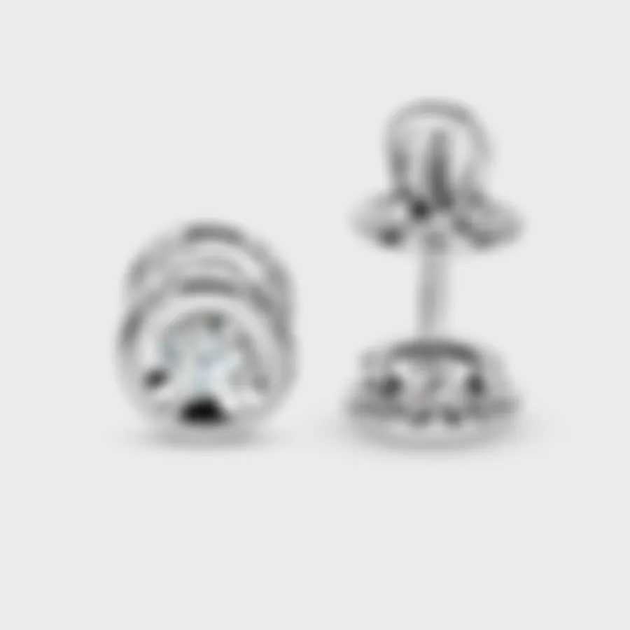 Heart white gold stud earrings by ValeOro with round diamonds, screw backs and heart-shaped side detail, side view