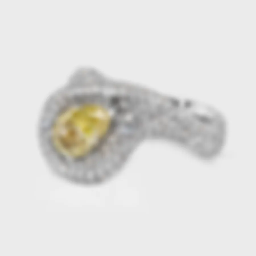 Yin-Yang white gold ring by ValeOro with a yellow pear diamond held between two waves of pavé, three-quarter view